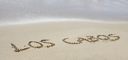 los cabos written on a wet beach sandの写真素材