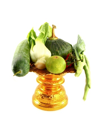 Vegetables mix on golden tray on white backgroundの写真素材