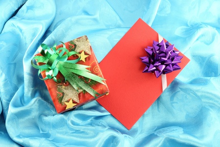 gift box and card on blue satinの写真素材