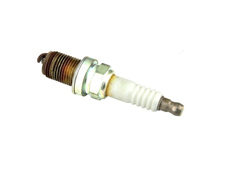 old burned spark plug on white backgroundの写真素材
