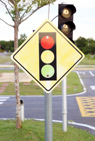 A road sign warning of a traffic light aheadの写真素材