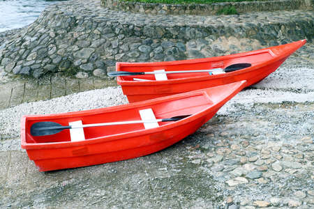 two red rowboat near the riverの写真素材