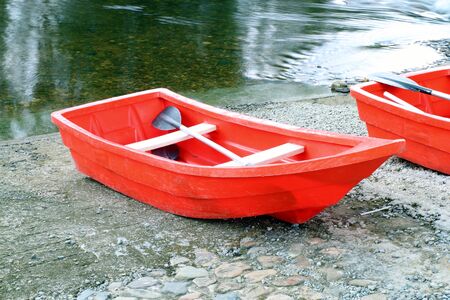 two red rowboat near the riverの写真素材