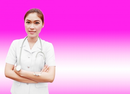 Young nurse with stethoscope on pink backgroundの写真素材