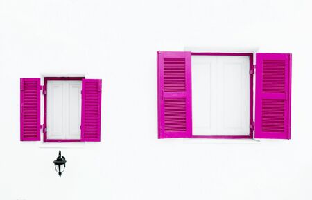 pink Greek Style windows and lamp on white wallの写真素材