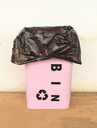 pink trash can with a plastic bagの写真素材