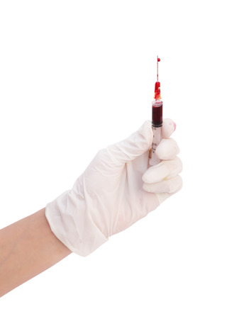 syringe with blood in hand on white background (with clipping path)の写真素材