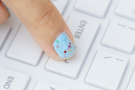 close-up finger pushing the enter button of keyboardの写真素材