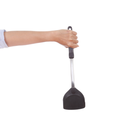 woman hand holding a kitchen spatula isolated on white backgroundの写真素材
