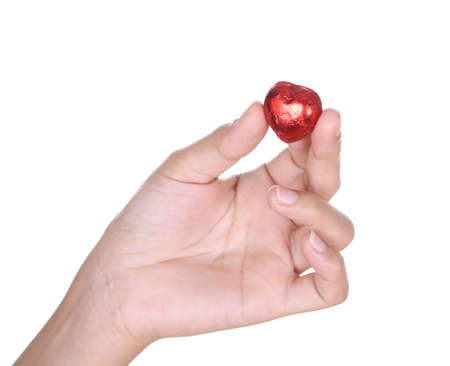 heart chocolate on hand isolated on white background