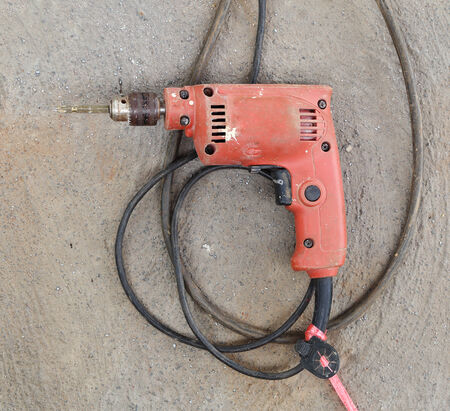 old drill with concrete backgroundの写真素材