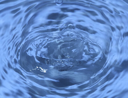 Close-up macro of a wave from water drop dropletの写真素材