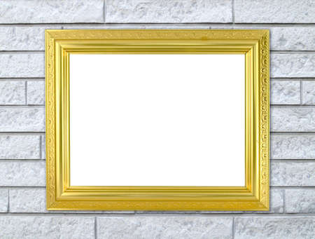 blank golden frame on brick stone wall backgroundの写真素材