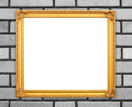 blank golden frame on brick stone wall backgroundの写真素材