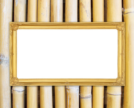 blank golden frame on bamboo wall backgroundの写真素材