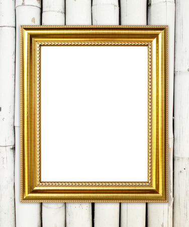 blank golden frame on bamboo wall backgroundの写真素材