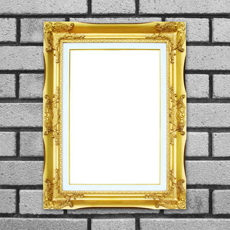 blank golden frame on brick stone wall backgroundの写真素材