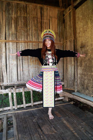 Traditionally dressed Mhong hill tribe woman in the wooden cottageの写真素材