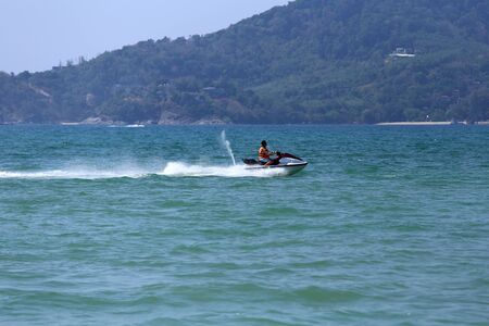 PHUKET, THAILAND - MARCH 15, 2015: Unidentified man drive on the jetski in Patong beach. on March 15, 2015 at Patong beach, Phuket, Thailandのeditorial素材