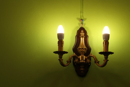 Lighted classic lamp on the green wallの写真素材