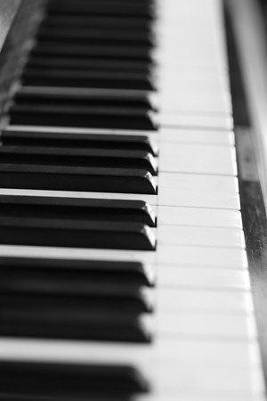 black and white piano keys and wood grain (soft focus)の写真素材