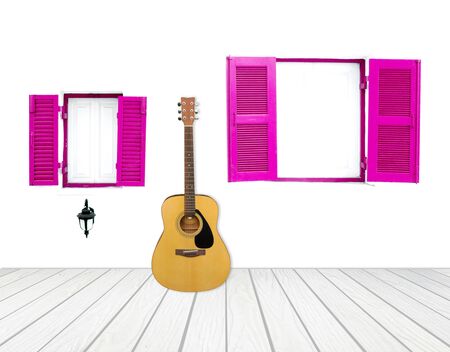 Guitar with window on cement wall and wood floorの写真素材