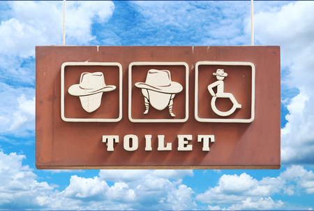 toilet sign hanging with blue sky backgroundの写真素材