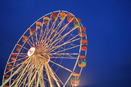 Ferris Wheel at amusement park at twilight time
