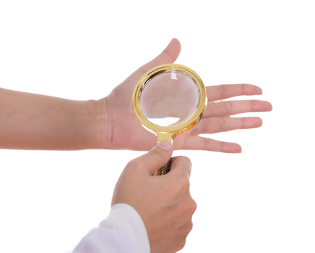 Palmistry, hands and magnifying glass isolated on white backgroundの写真素材