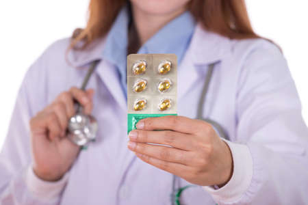 close up pills with female doctor isolated on white backgroundの写真素材