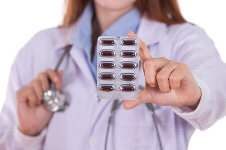close up pills with female doctor isolated on white backgroundの写真素材