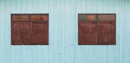 old wood window on blue wooden wall backgroundの写真素材