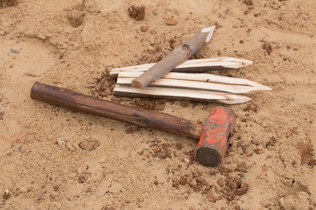hammer with eucalyptus pointed at construction site
