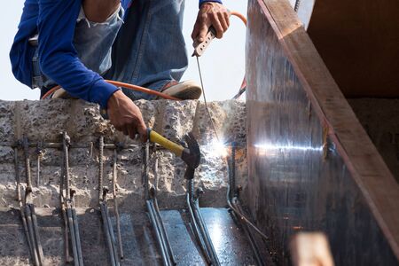 worker welding steel metal at construction siteの写真素材