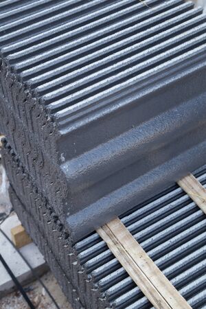 stack of new concrete roof tile (gray color) at construction siteの写真素材