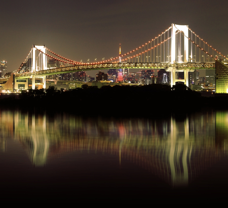 Tokyo Rainbow Bridge with mirror reflection at Night, Odaiba, Japanの写真素材