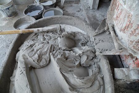 Mixing a cement in salver for applying constructionの写真素材