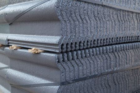 stack of new concrete roof tile (gray color) at construction siteの写真素材