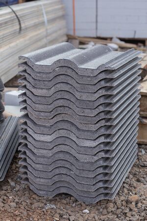 stack of new concrete roof tile (gray color) at construction siteの写真素材