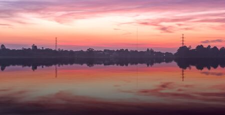 Huayyang reservoir at sunset with water reflection, Nakhon Ratchasima, Thailandの写真素材