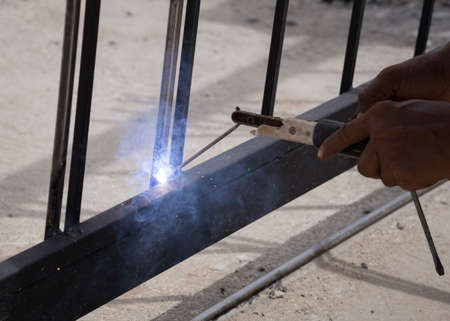 worker welding at manufacturing , welding door frames