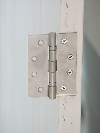 stainless door hinges on a white doorの写真素材