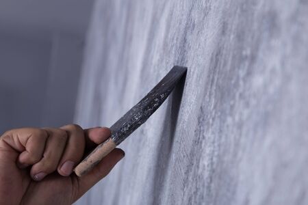 hand of worker use brush for color paint concrete Loft style on wallの写真素材
