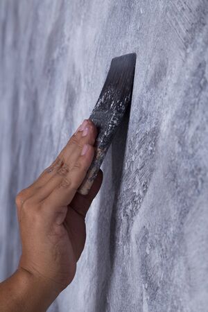 hand of worker use brush for color paint concrete Loft style on wallの写真素材