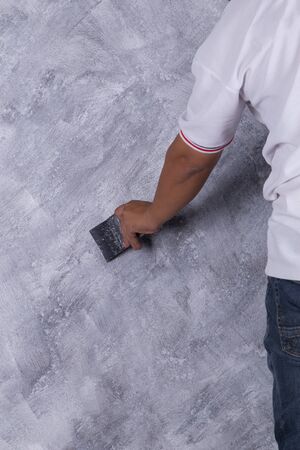 hand of worker use brush for color paint concrete Loft style on wallの写真素材
