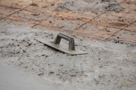trowel on a newly poured concrete floorの写真素材
