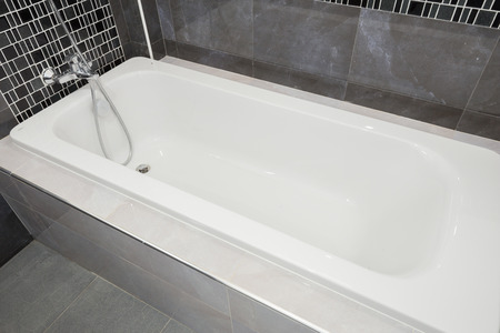 Bathtub white ceramic interior in bathroomの写真素材