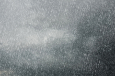 dark storm clouds with falling rainの写真素材