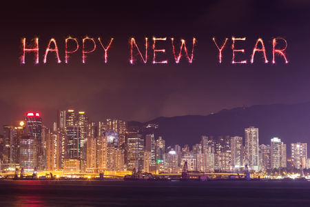 Happy New Year Fireworks celebrating over Hong Kong city at night, view from Victoria Harbourの写真素材