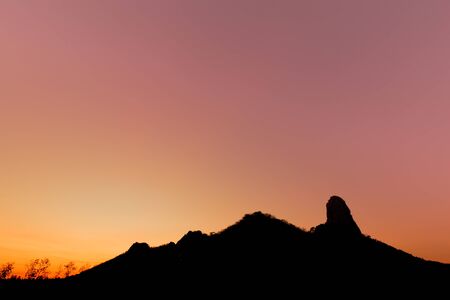 Silhouette of mountain at sunset, Lopburi, Thailandの写真素材